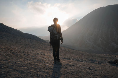 Full length of man standing on mountain against sky