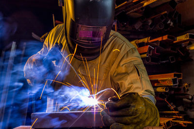 Welder welding in workshop