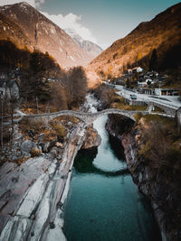 Scenic view of river flowing amidst mountains against sky