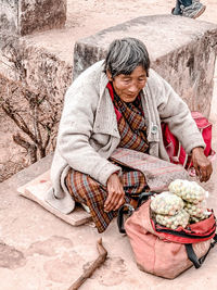 Girl holding ice cream cone on rock