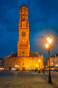 Belfry tower and grote markt square in bruges, belgium on dusk in twilight