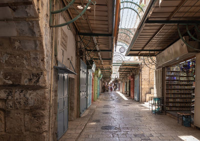 Empty alley amidst buildings in city