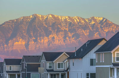 Low angle view of buildings and mountains against sky