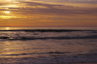 Golden sunset over sea waves