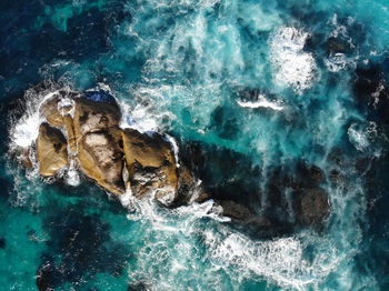 High angle view of rock formation in sea