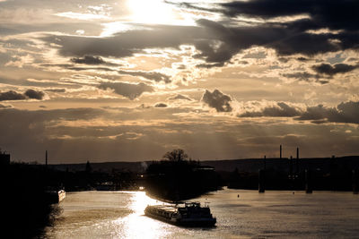 Scenic view of river against sky during sunset