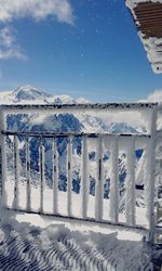 Scenic view of snow covered mountain against blue sky