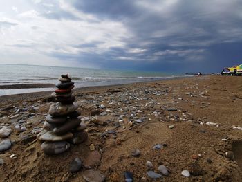 Rocks on beach against sky