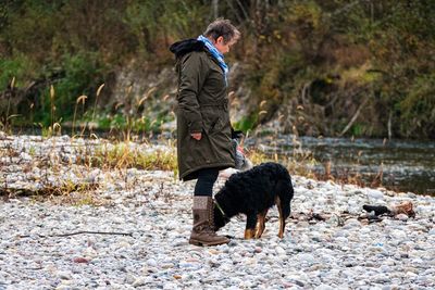 Man with dog standing on land