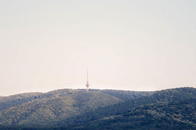 View of tower on mountain against sky