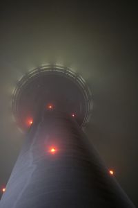 Low angle view of illuminated tower against sky at night