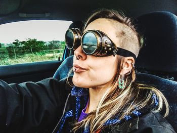 Portrait of woman wearing sunglasses in car