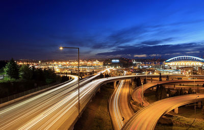 Illuminated cityscape against sky at night