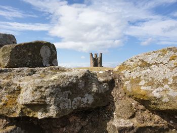 Old ruins of building against cloudy sky