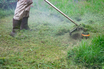 Low section of man working on field