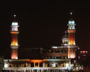 Low angle view of illuminated tower against sky at night