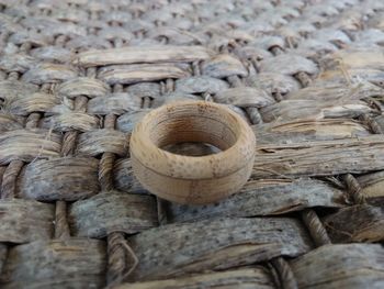 High angle view of wooden ring on thatched surface