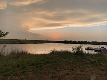 Scenic view of lake against sky during sunset