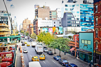 View of city street and buildings against sky