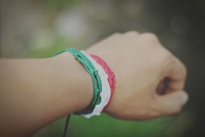 Cropped hand with colorful bracelets