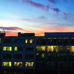 Buildings in city at sunset