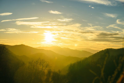 Scenic view of silhouette mountains against sky at sunset