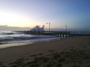 Scenic view of beach against sky during sunset