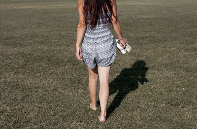Midsection of woman standing on field