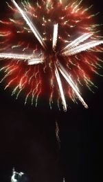 Low angle view of firework display at night