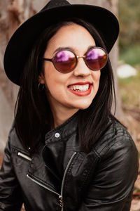 Close-up of woman wearing sunglasses standing outdoors