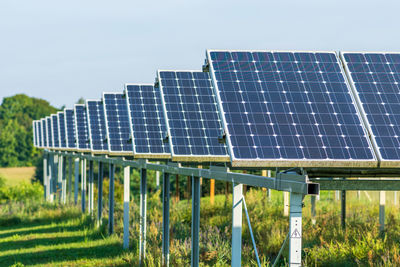 Solar panels in an agriculture green field in the countryside. solar power plant. blue solar panels