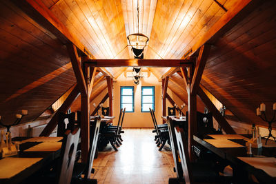 Empty chairs and tables in illuminated room