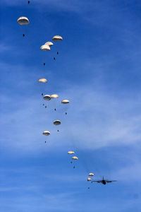 Low angle view of helicopter flying in sky