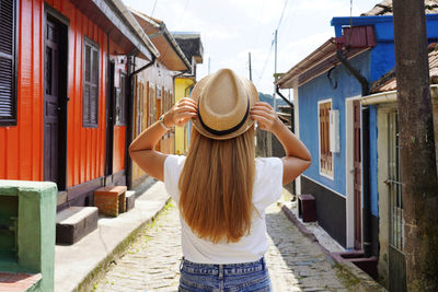 Back view of beautiful traveler girl enjoying visiting historic village of paranapiacaba, brazil.