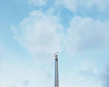 Low angle view of crane against sky