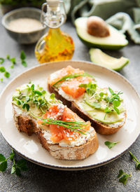 Sandwiches with salted salmon, avocado and microgreens. healthy food.