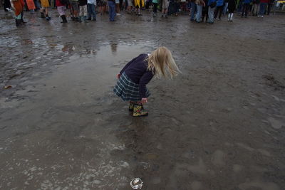 Young woman playing at lakeshore