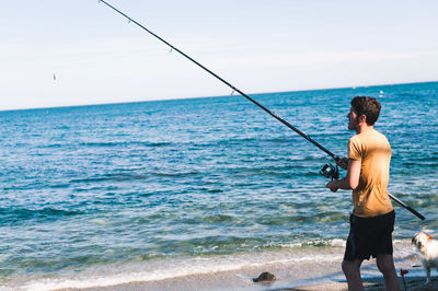 Rear view of man standing on beach