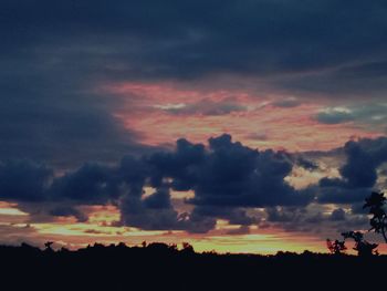 Scenic view of dramatic sky over silhouette landscape