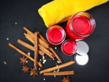 Directly above shot of red lip balm with spice on table