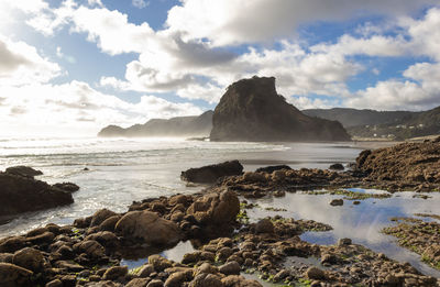 Scenic view of sea and mountains against sky