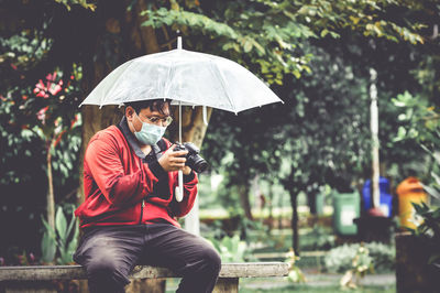 Midsection of woman with umbrella