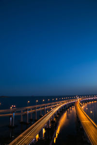 Illuminated light trails on bridge at night