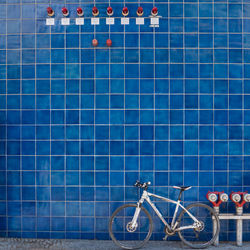 Bicycle parked against wall in swimming pool