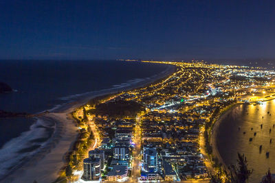 High angle view of illuminated city buildings at night