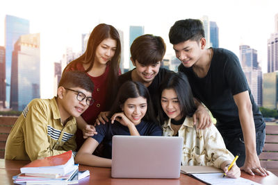 Group of friends sitting on smart phone