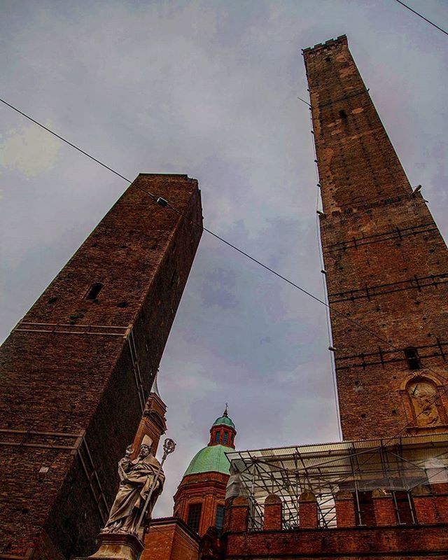 architecture, built structure, building exterior, low angle view, sky, tower, history, old, church, cloud - sky, religion, clock tower, tall - high, outdoors, no people, day, place of worship, cloud, city