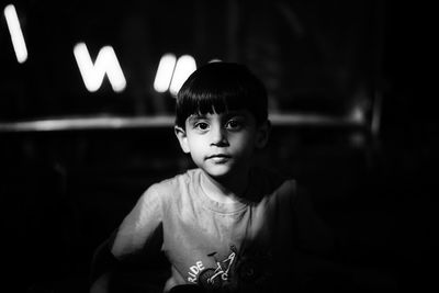 Portrait of cute boy in darkroom