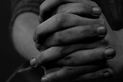 Close-up of person with hands clasped