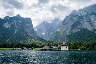 Scenic view of sea and mountains against sky